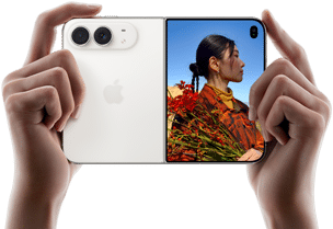 iPhone Duo, Star White color, held by two hands in horizontal orientation, unfolded, left panel shows 48MP Dual Fusion rear cameras, right panel shows person getting their picture taken on outer display, the subject of the photo is able to see their face as their picture is getting taken using Duo Preview