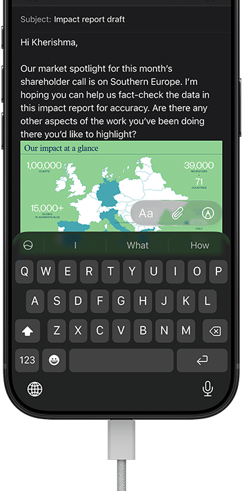 iPhone 18 Pro, black, connected to a charger, screen shows a work email in Mail